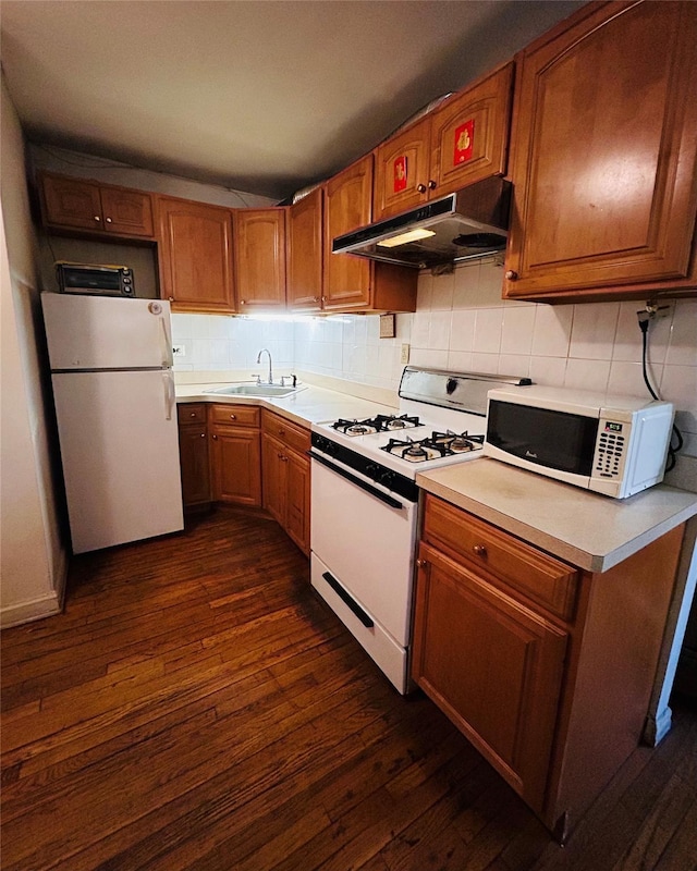 13705 Franklin Ave Unit 3J, Flushing, NY 11355 - kitchen with white appliances, backsplash, under cabinet range hood, and dark wood-style floors