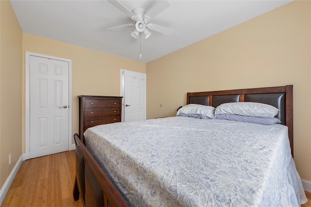 bedroom with baseboards, ceiling fan, and light wood finished floors