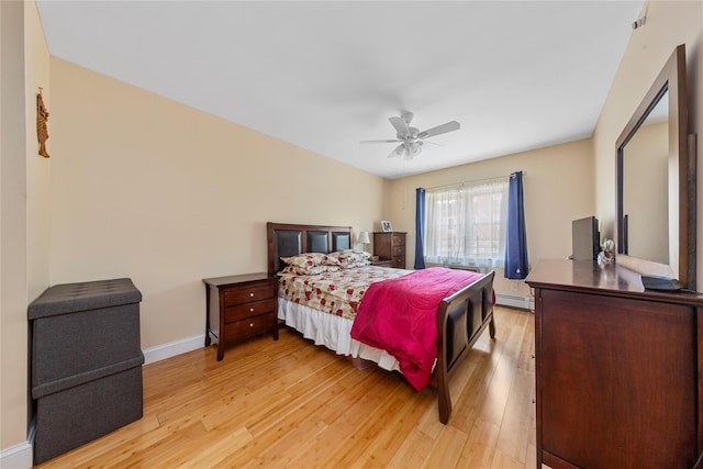 bedroom with baseboards, light wood-type flooring, ceiling fan, and a baseboard radiator