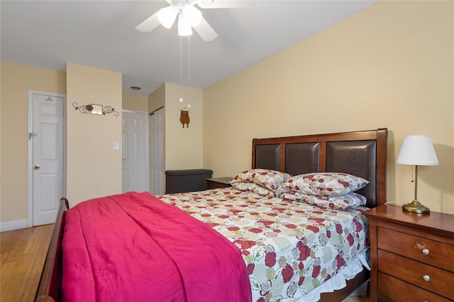 bedroom with baseboards, a ceiling fan, and wood finished floors