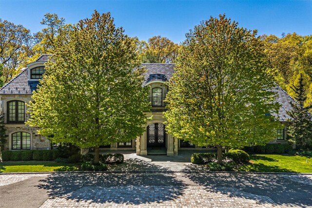167 Brookville Rd, Brookville, NY 11545 - french country home with french doors, a high end roof, decorative driveway, and stone siding