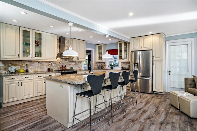 437 Carroll Ave, Mamaroneck, NY 10543 - kitchen with appliances with stainless steel finishes, wall chimney exhaust hood, decorative backsplash, a sink, and dark wood-style floors