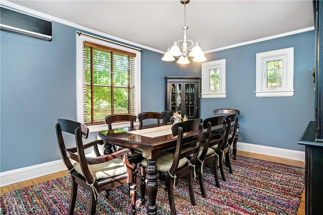437 Carroll Ave, Mamaroneck, NY 10543 - dining room with a wall mounted air conditioner, a chandelier, healthy amount of natural light, wood finished floors, and ornamental molding