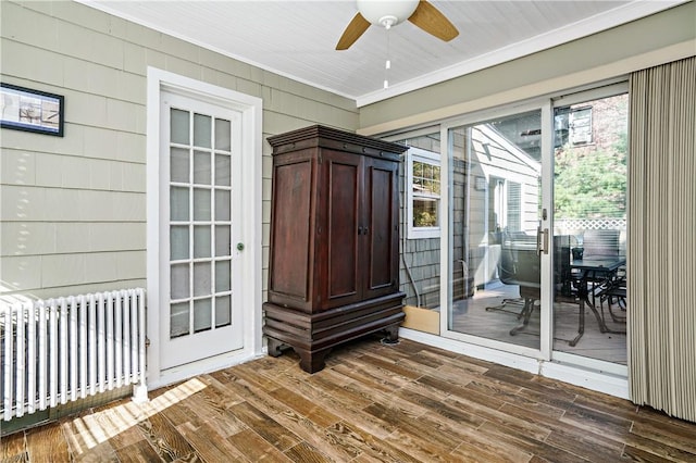 437 Carroll Ave, Mamaroneck, NY 10543 - spare room featuring radiator, crown molding, ceiling fan, dark wood finished floors, and wooden walls