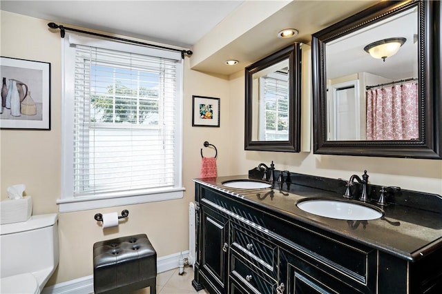 437 Carroll Ave, Mamaroneck, NY 10543 - bathroom featuring baseboards, double vanity, toilet, tile patterned floors, and recessed lighting