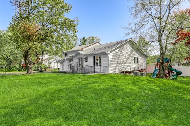 104 W Maple Ave, Monsey, NY 10952 - rear view of property featuring a lawn, roof with shingles, and a playground