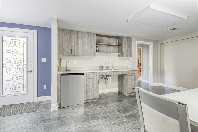 104 W Maple Ave, Monsey, NY 10952 - kitchen featuring visible vents, modern cabinets, fridge, a sink, and light countertops