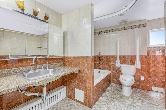 104 W Maple Ave, Monsey, NY 10952 - full bath featuring a sink, toilet, tile patterned floors, tile walls, and tiled tub