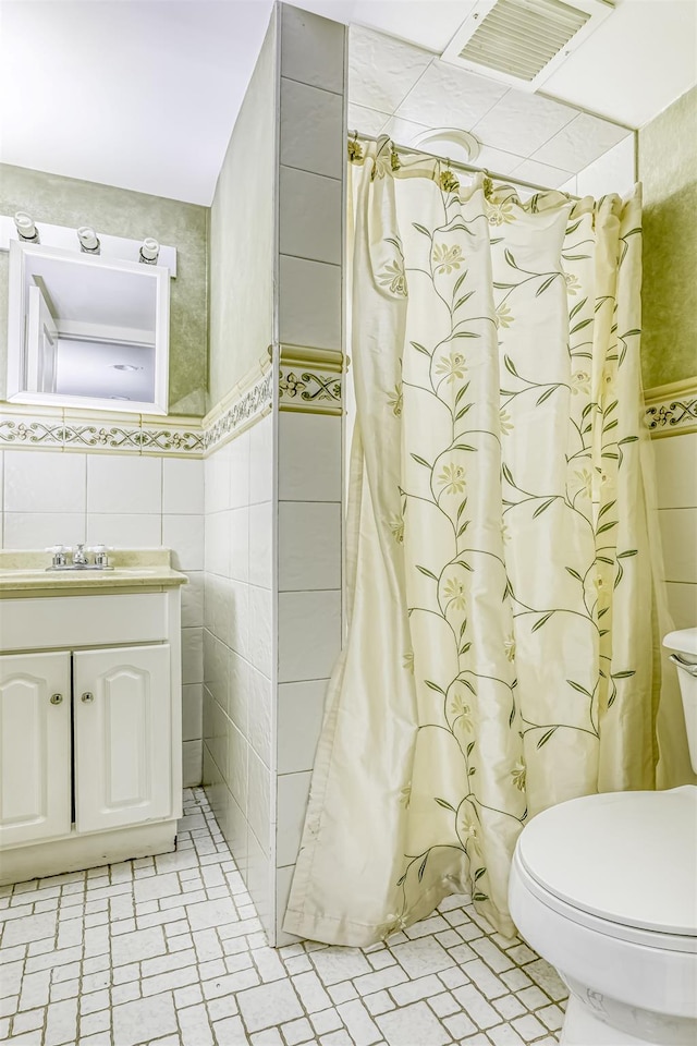 104 W Maple Ave, Monsey, NY 10952 - bathroom with vanity, visible vents, toilet, tile walls, and a shower with curtain