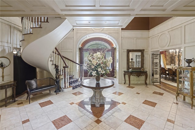 822 Bryant Ave, Roslyn Harbor, NY 11576 - entrance foyer featuring a decorative wall, stairs, and a notable chandelier