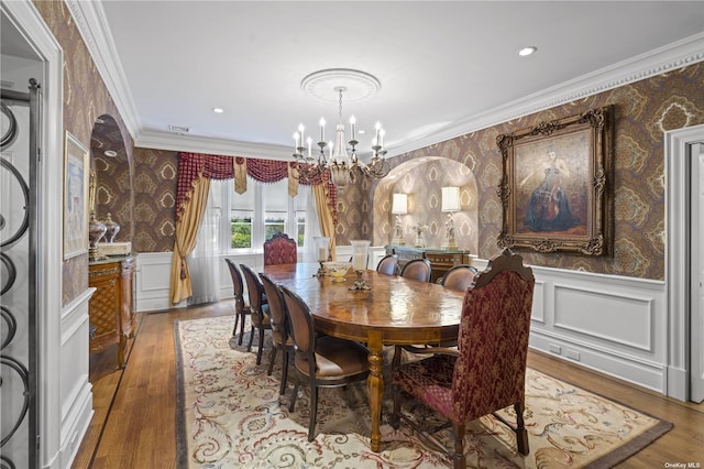 822 Bryant Ave, Roslyn Harbor, NY 11576 - dining room with wallpapered walls, a notable chandelier, ornamental molding, and wood finished floors