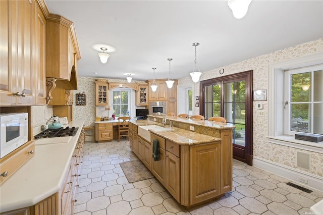 822 Bryant Ave, Roslyn Harbor, NY 11576 - kitchen with light tile patterned flooring, wallpapered walls, appliances with stainless steel finishes, and a sink