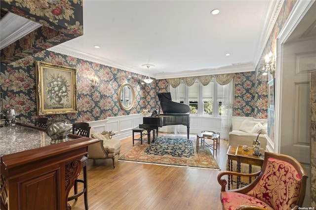 822 Bryant Ave, Roslyn Harbor, NY 11576 - sitting room with crown molding, wainscoting, wallpapered walls, and hardwood / wood-style floors