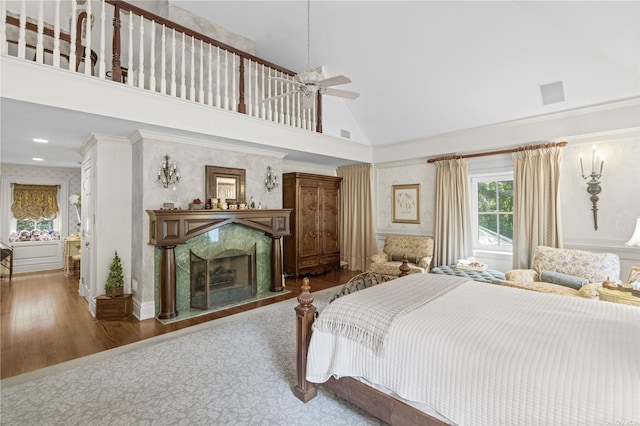 822 Bryant Ave, Roslyn Harbor, NY 11576 - bedroom featuring visible vents, wood finished floors, high vaulted ceiling, wallpapered walls, and a premium fireplace