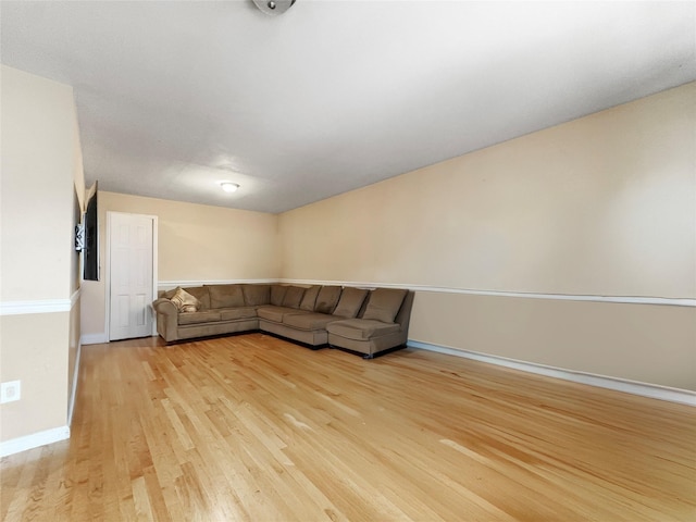 unfurnished living room with baseboards and light wood finished floors