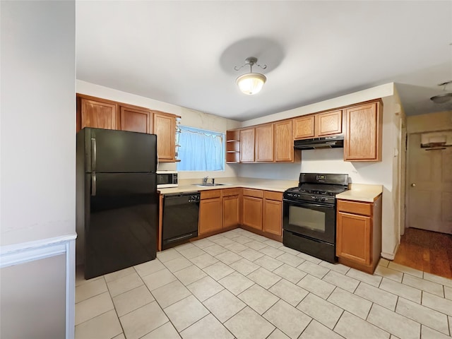 kitchen with open shelves, a sink, light countertops, black appliances, and under cabinet range hood