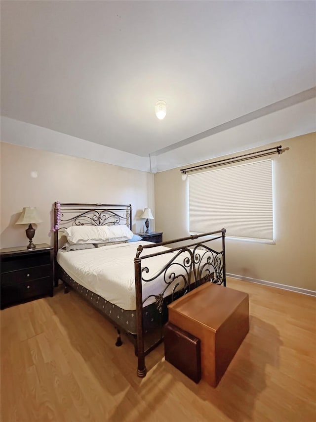 bedroom featuring baseboards and light wood-style floors