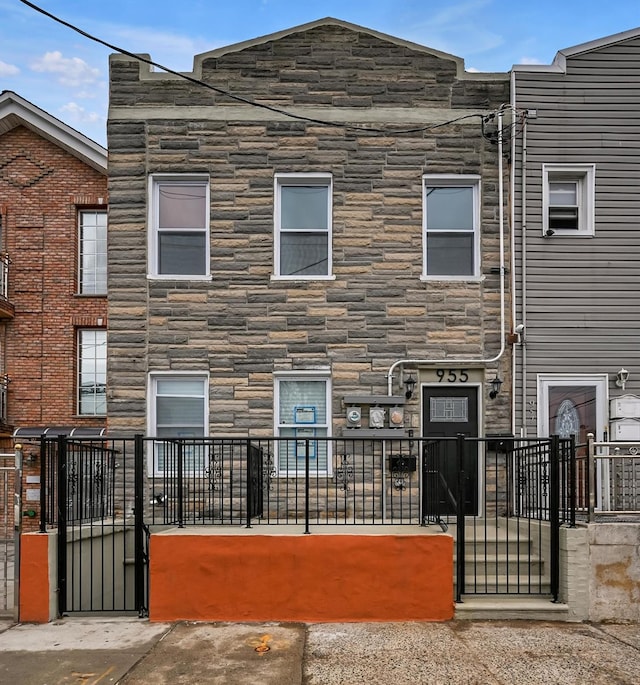 955 Crescent St, Brooklyn, NY 11208 - multi unit property with a gate, a fenced front yard, and stone siding