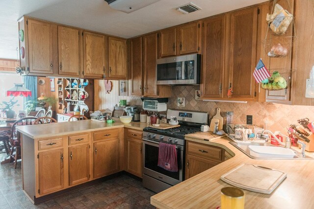 3 Cloister Ln, Middle Island, NY 11953 - kitchen featuring light countertops, appliances with stainless steel finishes, a sink, and visible vents