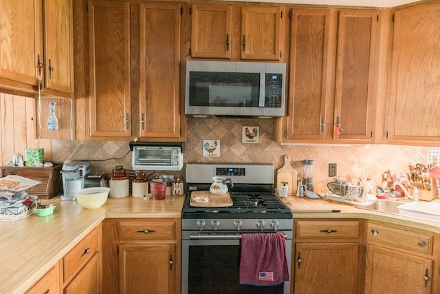 3 Cloister Ln, Middle Island, NY 11953 - kitchen featuring light countertops, stainless steel appliances, brown cabinetry, and tasteful backsplash