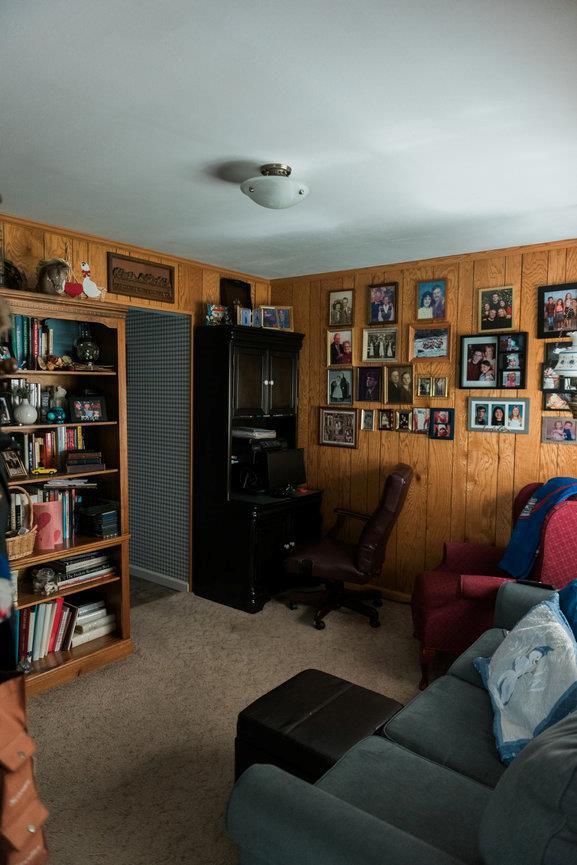 3 Cloister Ln, Middle Island, NY 11953 - living room featuring wooden walls and carpet floors