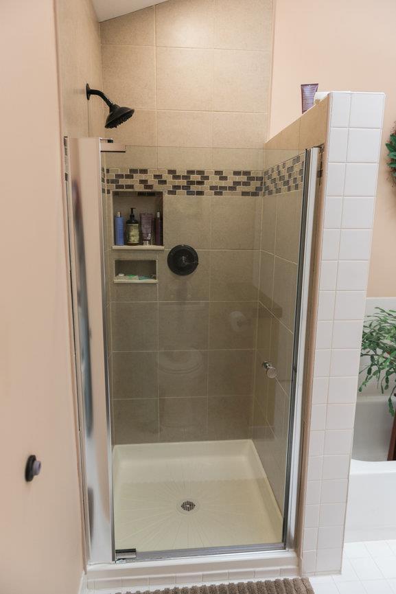 3 Cloister Ln, Middle Island, NY 11953 - bathroom featuring a shower stall and tile patterned flooring