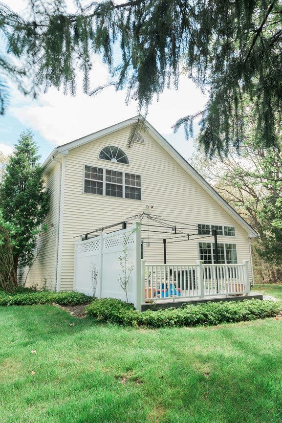 3 Cloister Ln, Middle Island, NY 11953 - back of house featuring a yard and a deck