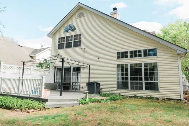3 Cloister Ln, Middle Island, NY 11953 - rear view of house with fence, a deck, a chimney, central air condition unit, and a yard