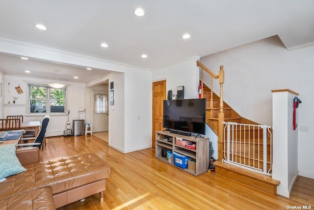 living area with crown molding, baseboards, recessed lighting, and wood finished floors