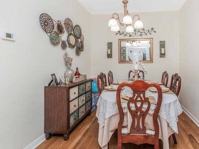 314 Mclean Ave, Yonkers, NY 10705 - dining space featuring baseboards, light wood finished floors, and a notable chandelier