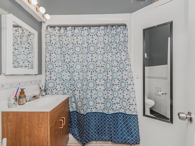 314 Mclean Ave, Yonkers, NY 10705 - bathroom featuring vanity, a shower with curtain, toilet, and tile walls