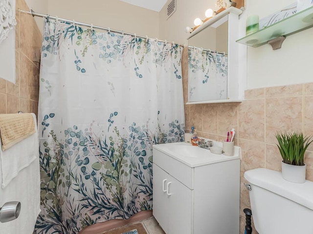 314 Mclean Ave, Yonkers, NY 10705 - full bathroom with tile walls, vanity, toilet, and visible vents
