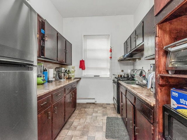 314 Mclean Ave, Yonkers, NY 10705 - kitchen featuring freestanding refrigerator, baseboard heating, light countertops, tasteful backsplash, and gas stove