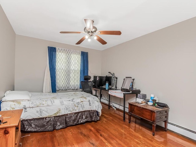 314 Mclean Ave, Yonkers, NY 10705 - bedroom with a baseboard radiator, a ceiling fan, and wood finished floors