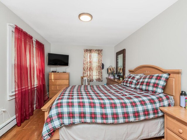 314 Mclean Ave, Yonkers, NY 10705 - bedroom with baseboard heating and wood finished floors