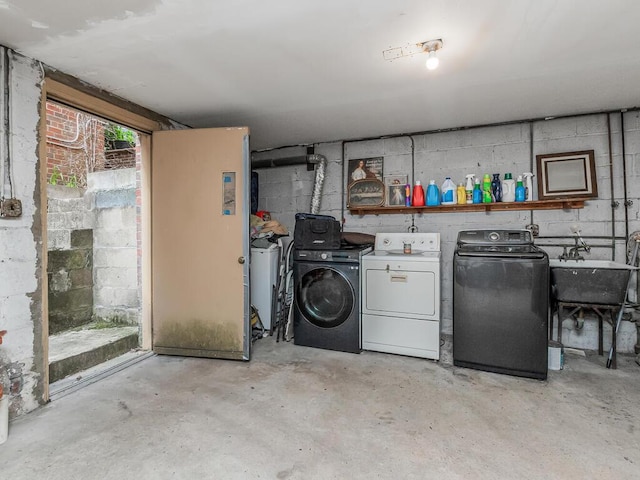 314 Mclean Ave, Yonkers, NY 10705 - laundry area featuring concrete block wall, laundry area, a sink, and washer and clothes dryer