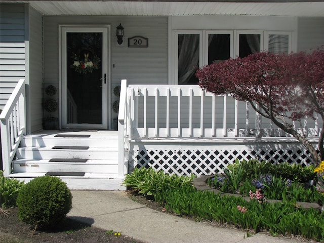 20 Clover St, Mastic, NY 11950 - view of exterior entry featuring a porch