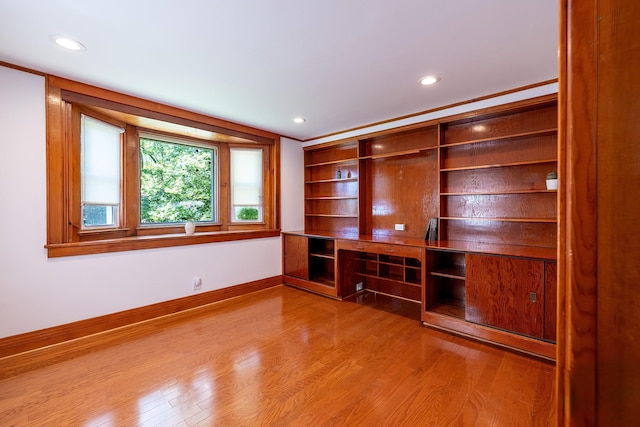 interior space with baseboards, recessed lighting, and wood finished floors