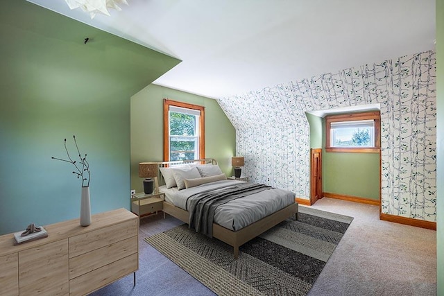 bedroom with carpet floors, baseboards, vaulted ceiling, and wallpapered walls