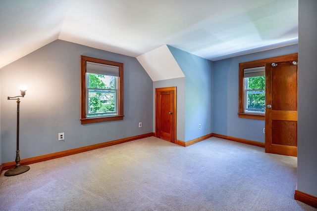 bonus room featuring carpet floors, plenty of natural light, baseboards, and lofted ceiling