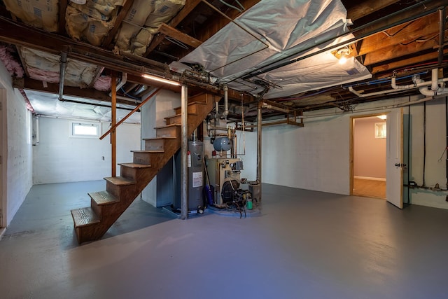 below grade area featuring stairway, a heating unit, and water heater