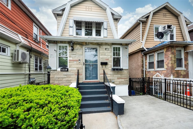 4220 Wickham Ave, Bronx, NY 10466 - dutch colonial featuring ac unit, stone siding, and a gambrel roof