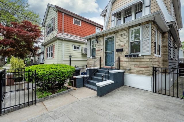 4220 Wickham Ave, Bronx, NY 10466 - view of front facade featuring fence, a gate, and stone siding