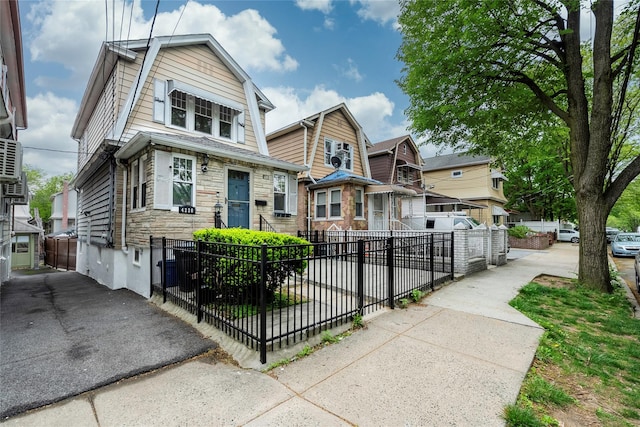 4220 Wickham Ave, Bronx, NY 10466 - dutch colonial featuring a residential view, a fenced front yard, a gambrel roof, and stone siding