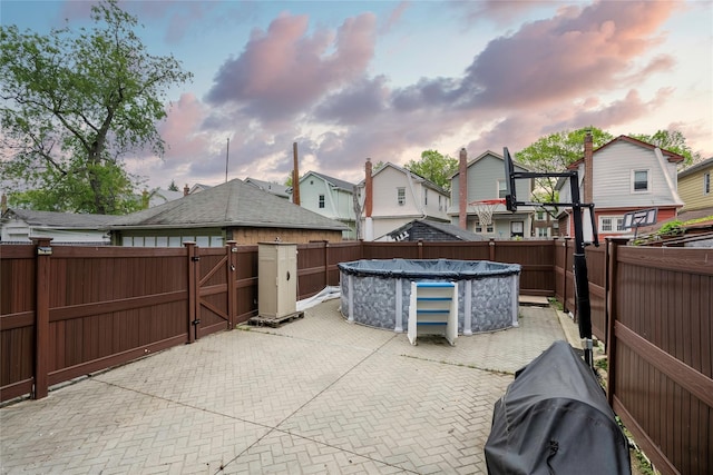 4220 Wickham Ave, Bronx, NY 10466 - patio terrace at dusk with a fenced in pool, a gate, a fenced backyard, and a residential view