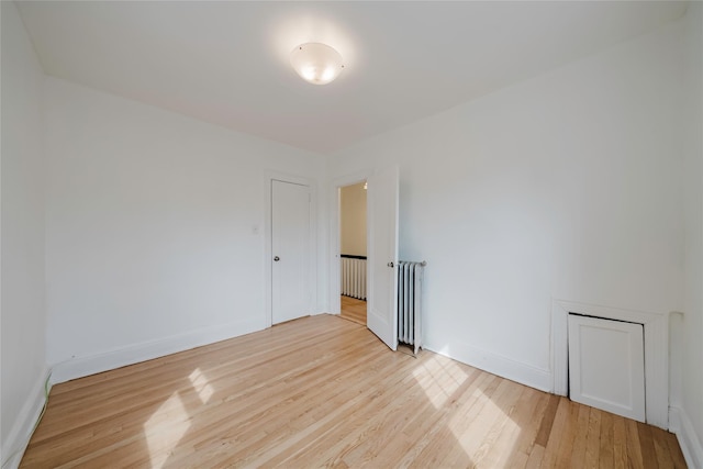 4220 Wickham Ave, Bronx, NY 10466 - empty room with baseboards, radiator heating unit, and wood finished floors