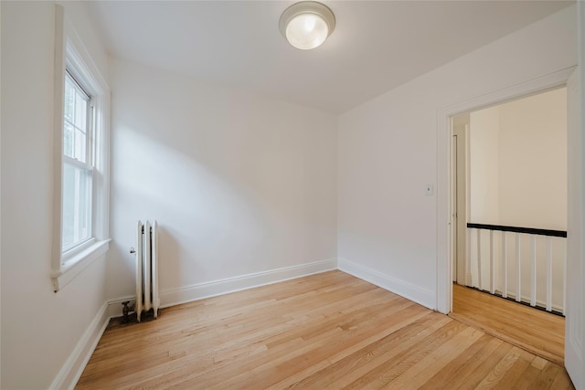 4220 Wickham Ave, Bronx, NY 10466 - empty room featuring light wood-style floors, baseboards, and radiator heating unit