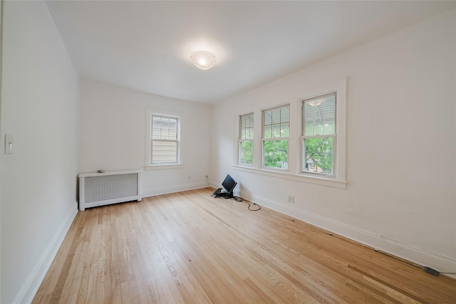 4220 Wickham Ave, Bronx, NY 10466 - empty room with baseboards, radiator heating unit, and hardwood / wood-style flooring