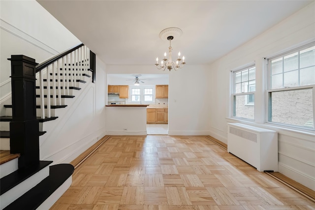 4220 Wickham Ave, Bronx, NY 10466 - unfurnished dining area with stairway, baseboards, radiator, and ceiling fan with notable chandelier