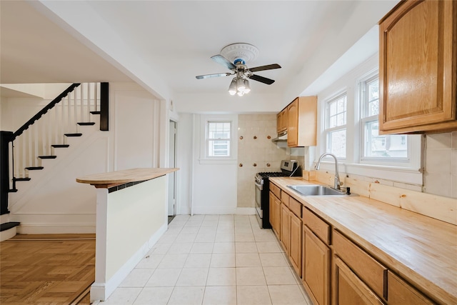 4220 Wickham Ave, Bronx, NY 10466 - kitchen featuring backsplash, a ceiling fan, a sink, stainless steel gas range, and under cabinet range hood